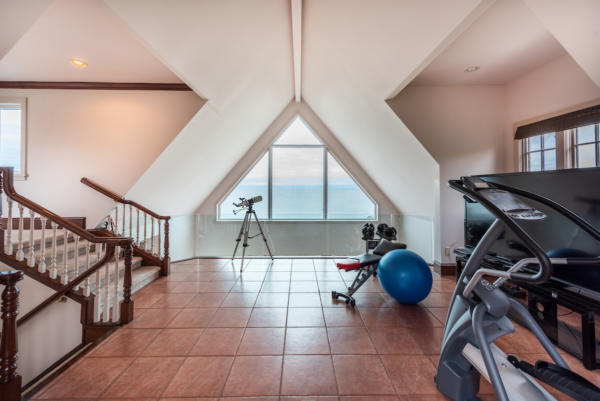 Fitness room with water views at ocean front home